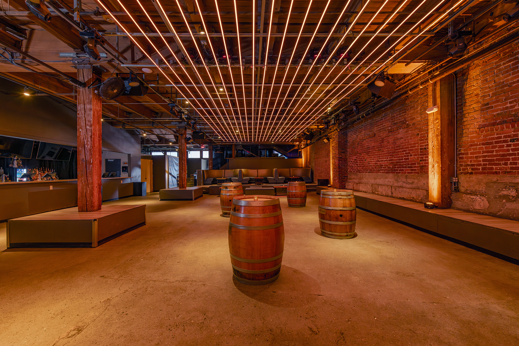 Lounge area with wine barrels and exposed brick